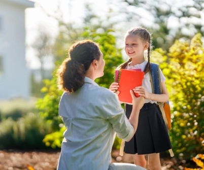 a person giving a child a book to her mother